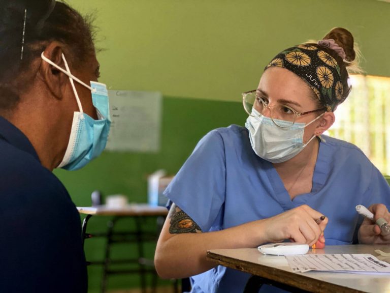Nurse attending patient in Dominican medical clinic